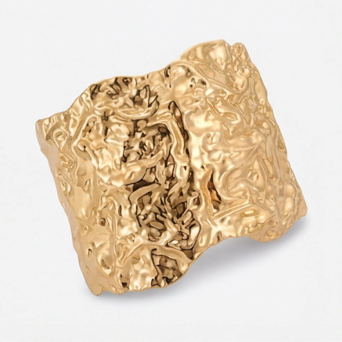Wide gold-tone cuff bracelet angled to show the raised uneven surface