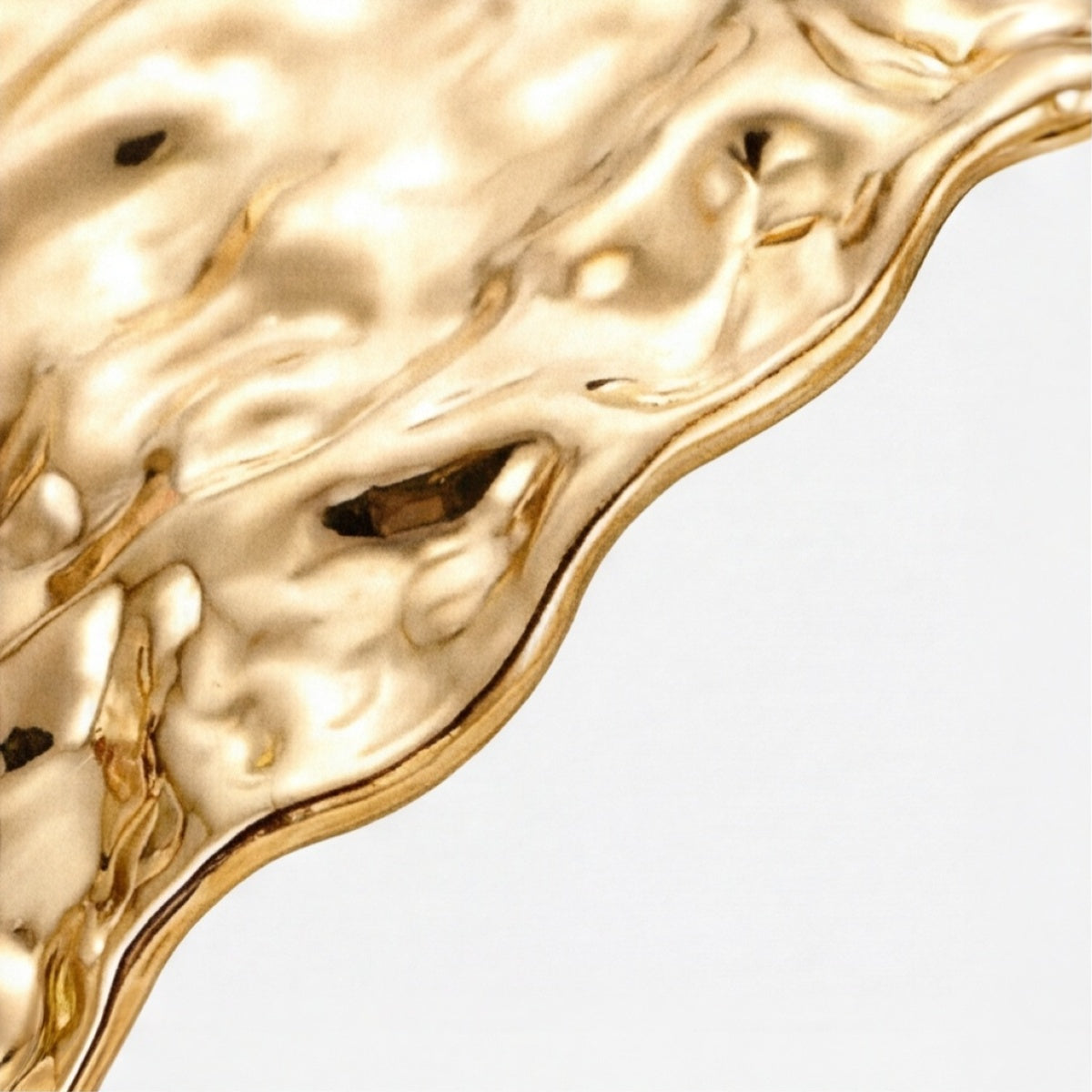 Close-up of the gold-tone cuff bracelet raised irregular texture