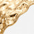 Close-up of the gold-tone cuff bracelet raised irregular texture