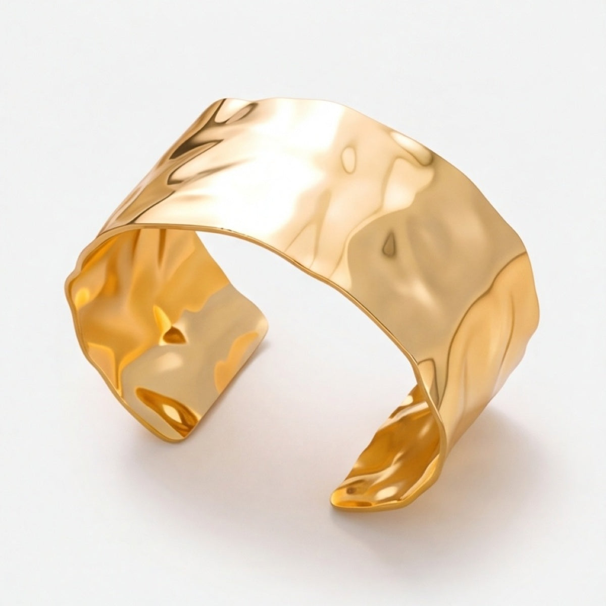 Wide gold-tone hammered open cuff bracelet shown at an angle