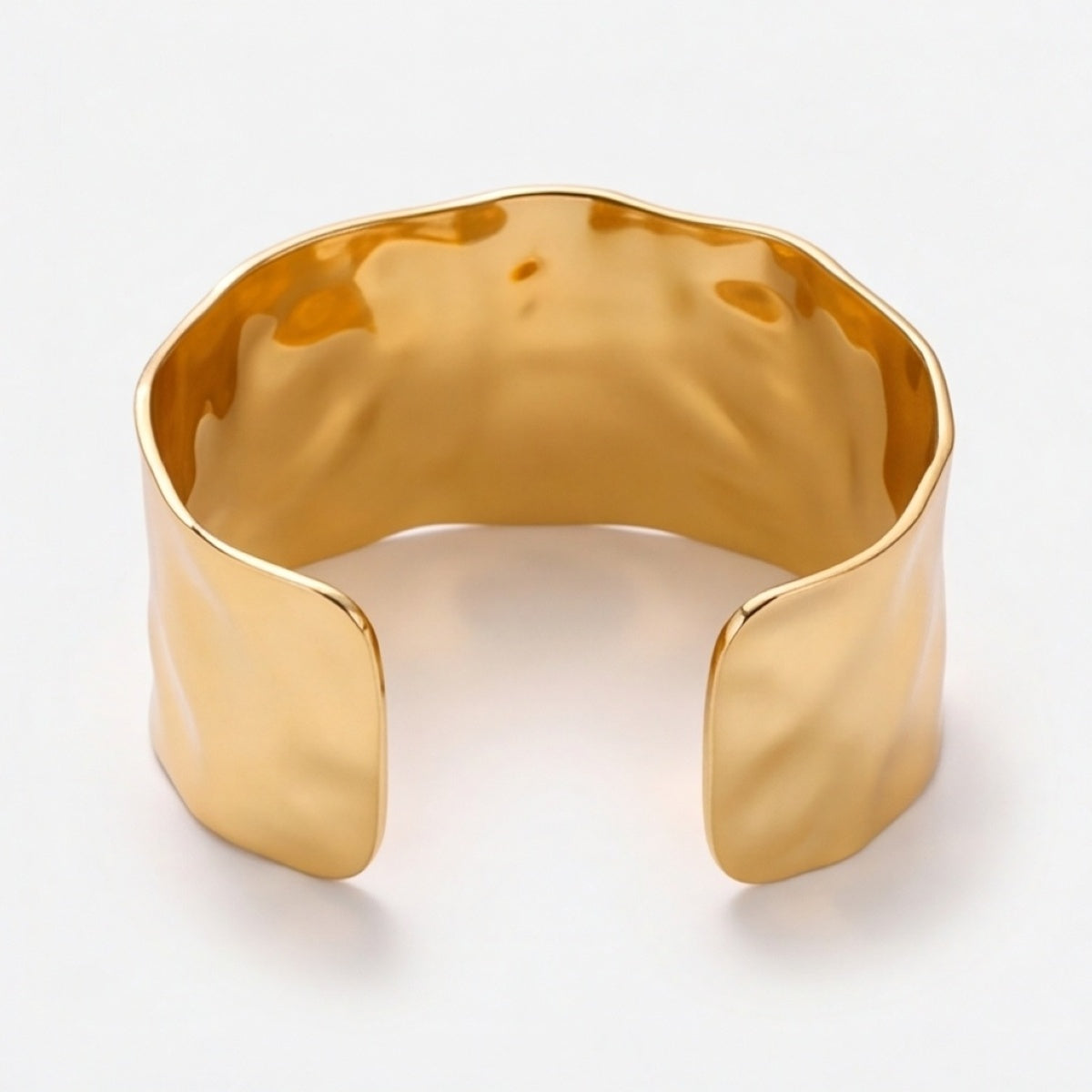 Wide gold-tone open cuff bracelet viewed from the back