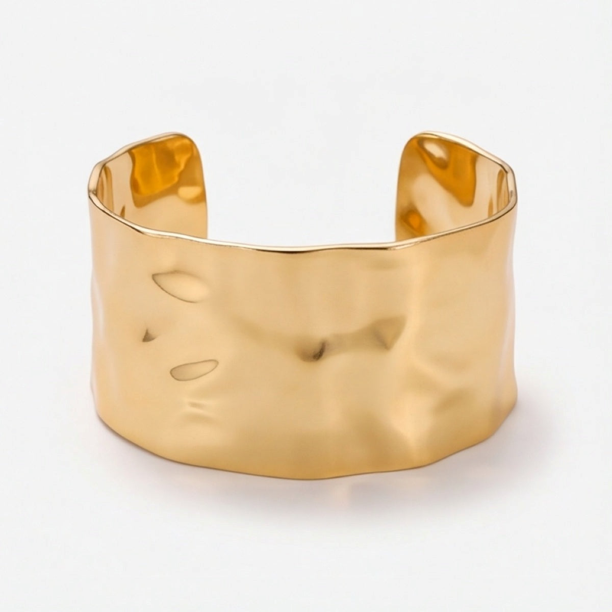 Front-facing detail of the wide gold-tone hammered open cuff bracelet